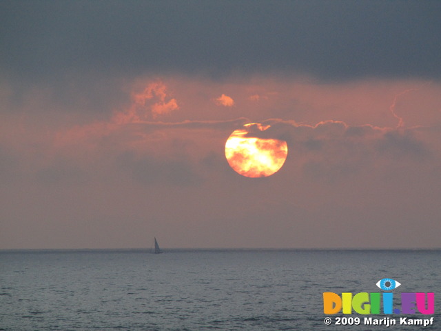 SX07463 Sailboat on horizon at sunset